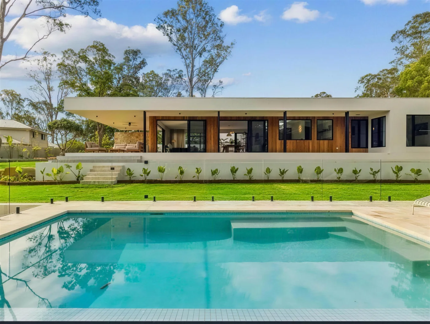Smooth grey rendered home with vertical timber battens