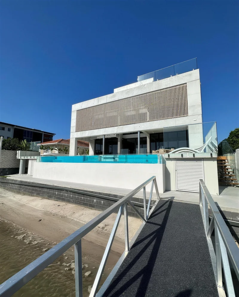 Three-storey rendered home with glass balustrades