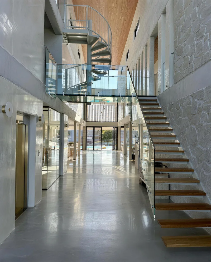 Curved white plaster walls lit by a round skylight